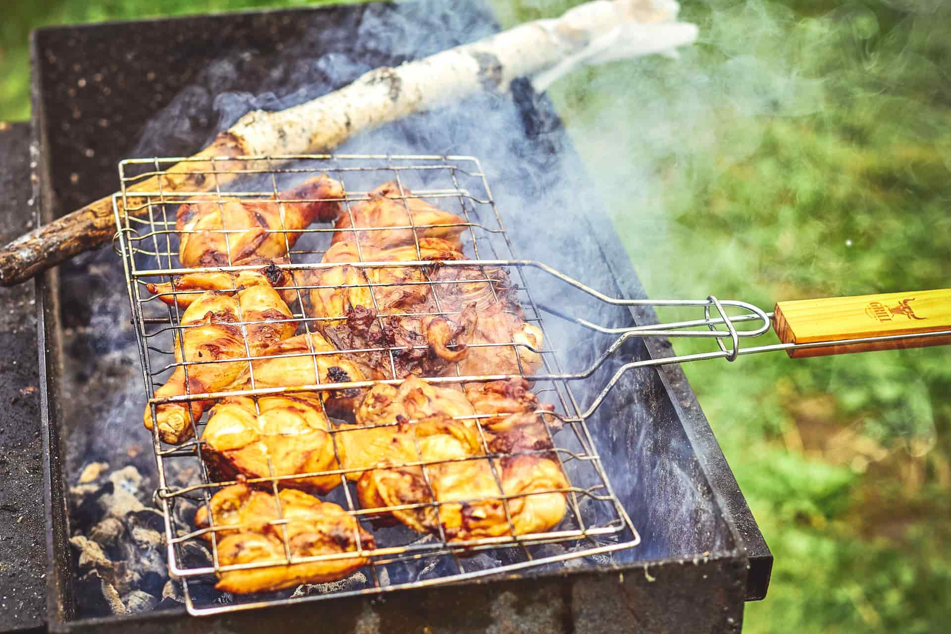 Chicken cooking over a charcoal grill
