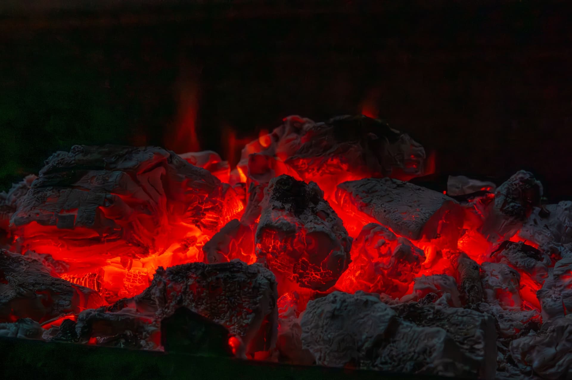 Glowing charcoal embers ashed over and ready to cook
