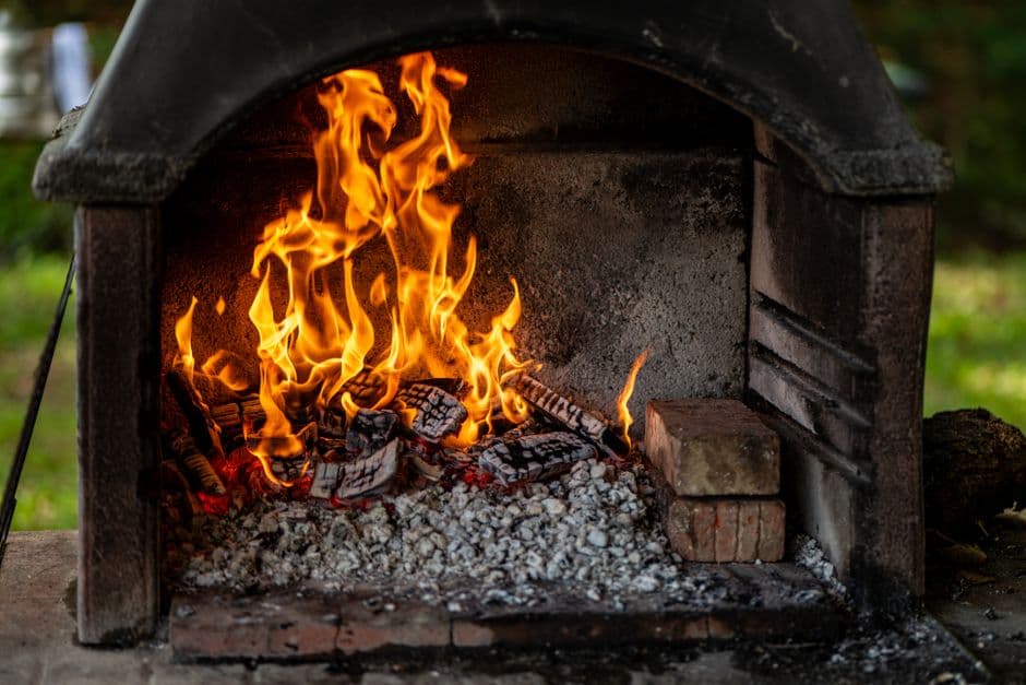 Logs burning in an outdoor fire pit with the flames well established