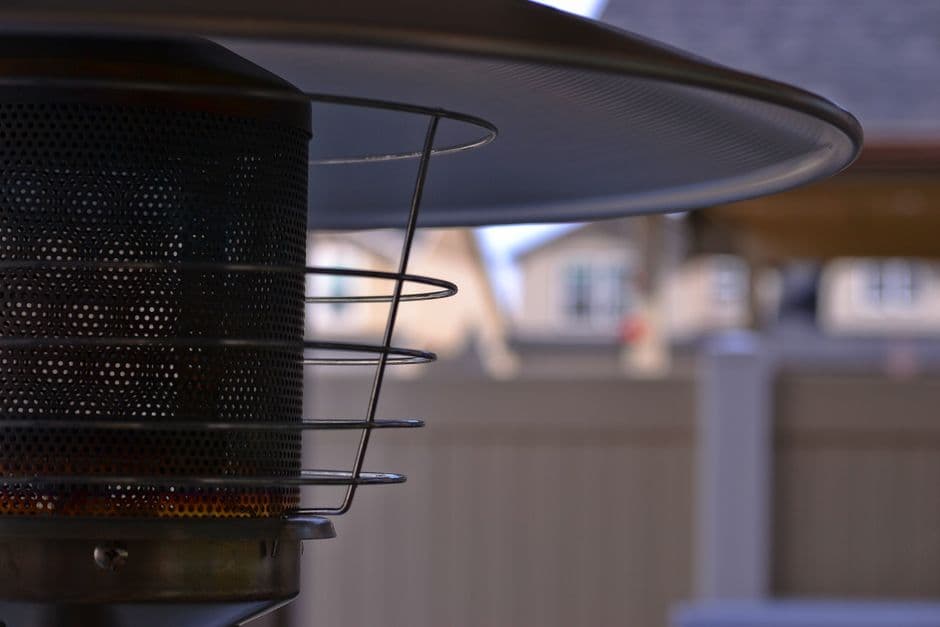 A freestanding outdoor patio heater on a residential patio